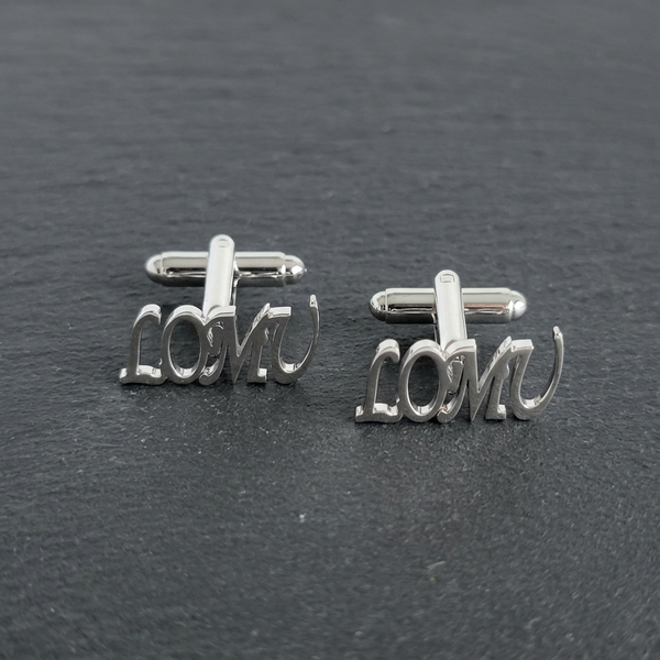 LOMU cuff links on a charcoal stone tabletop